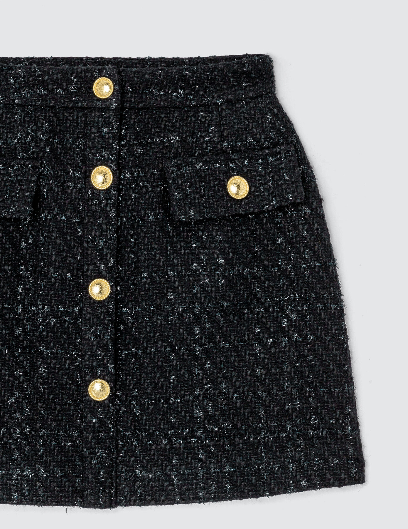 Jupe courte en tweed boutons dorés