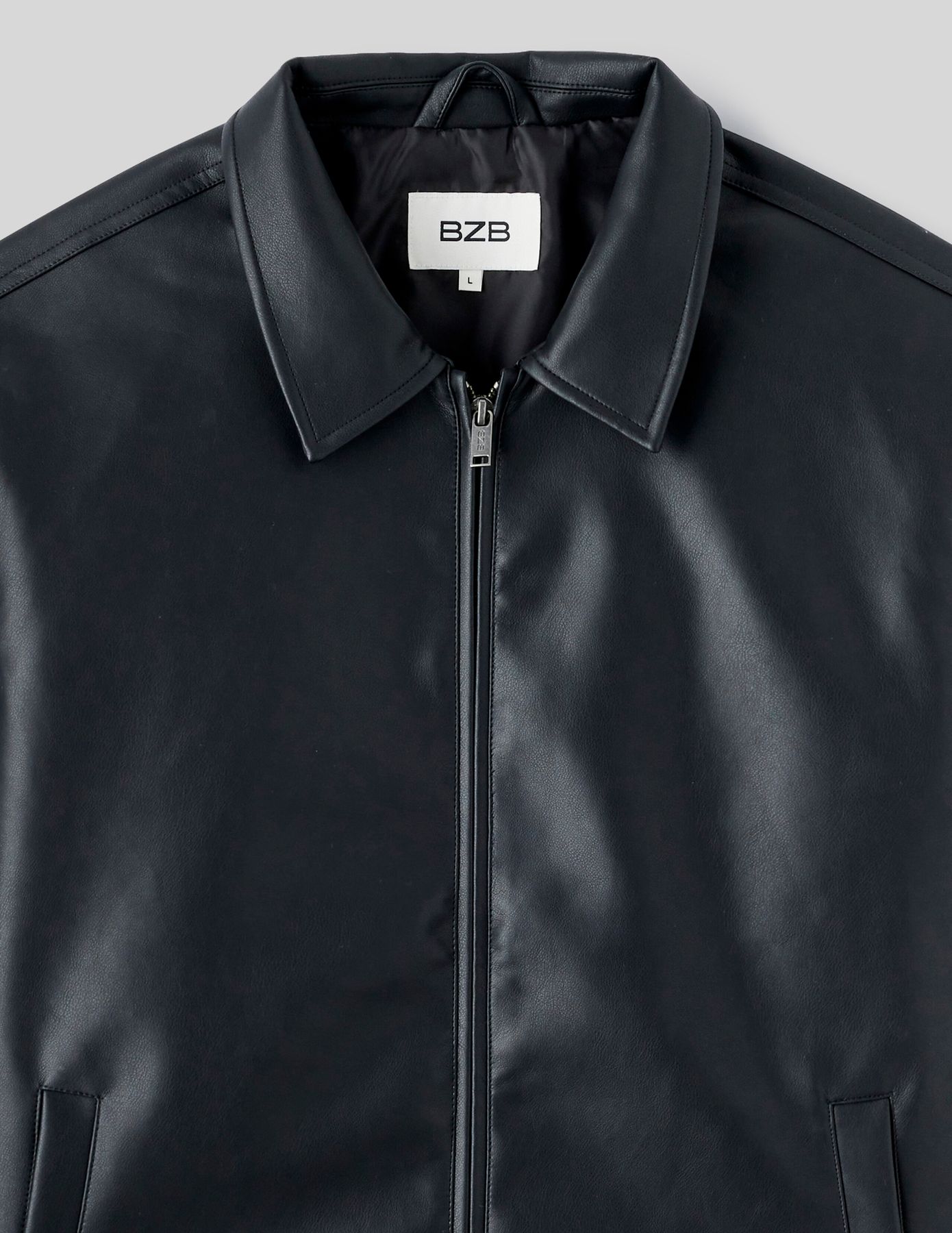 Blouson zippé en tissu enduit