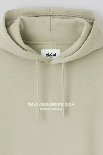 Sweat à capuche message brodé