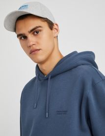 Sweat à capuche message brodé